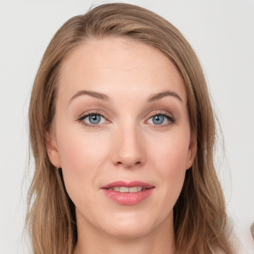 Joyful white young-adult female with long  brown hair and blue eyes