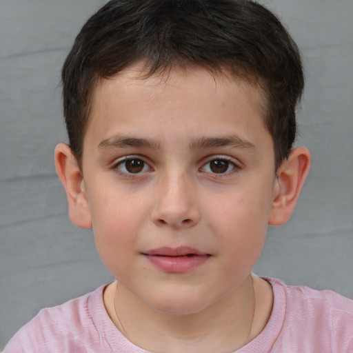 Joyful white child male with short  brown hair and brown eyes