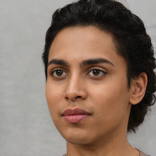 Joyful latino young-adult female with medium  black hair and brown eyes