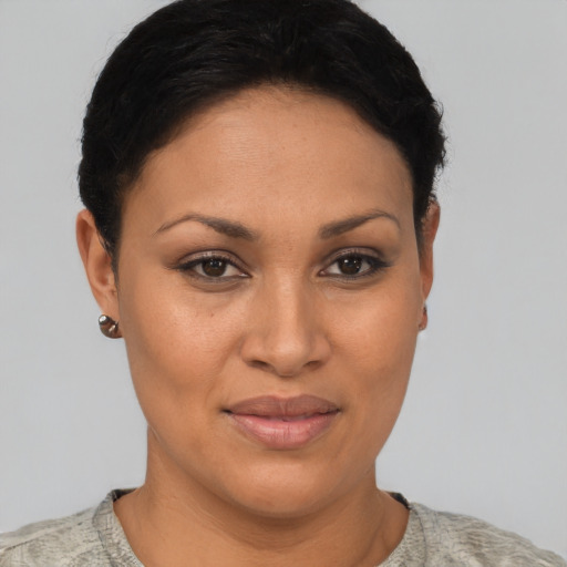 Joyful latino young-adult female with short  brown hair and brown eyes