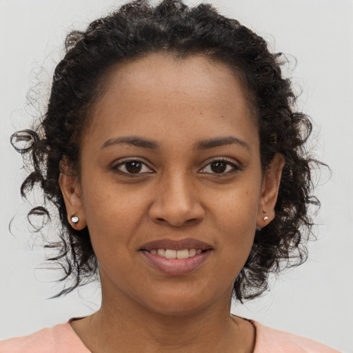Joyful black young-adult female with short  brown hair and brown eyes