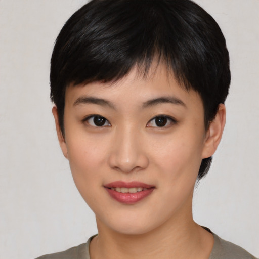 Joyful asian young-adult female with short  black hair and brown eyes
