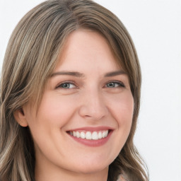 Joyful white young-adult female with long  brown hair and blue eyes