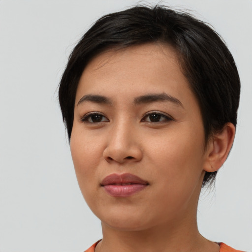 Joyful asian young-adult female with short  brown hair and brown eyes