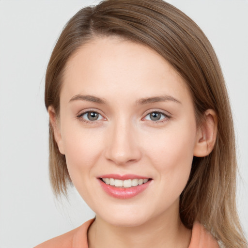 Joyful white young-adult female with long  brown hair and grey eyes