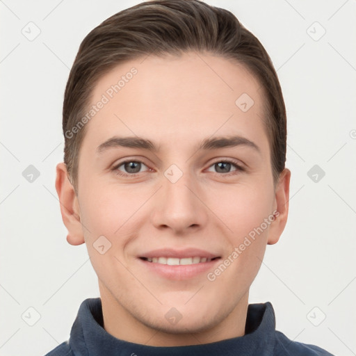 Joyful white young-adult male with short  brown hair and grey eyes