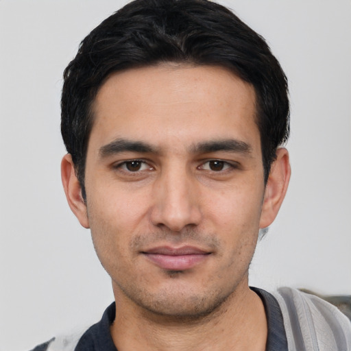 Joyful white young-adult male with short  black hair and brown eyes