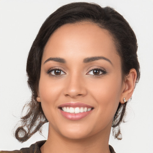 Joyful latino young-adult female with long  brown hair and brown eyes