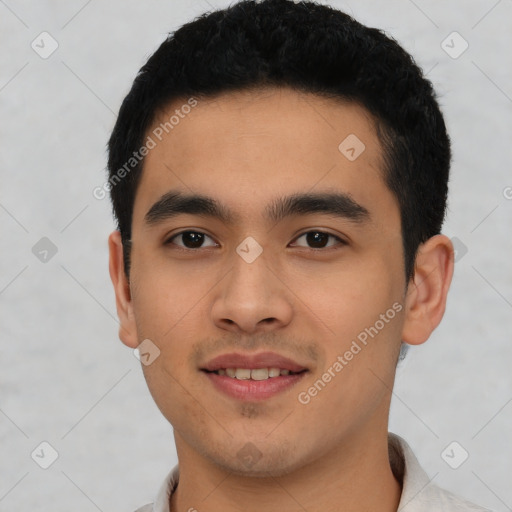 Joyful latino young-adult male with short  black hair and brown eyes