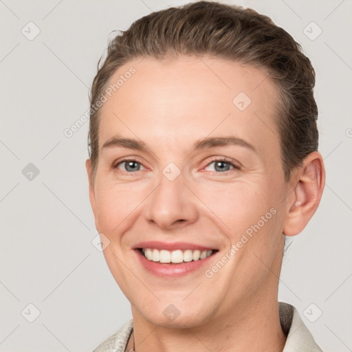 Joyful white young-adult female with short  brown hair and grey eyes