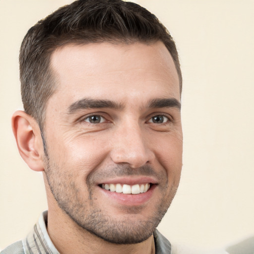 Joyful white young-adult male with short  brown hair and brown eyes