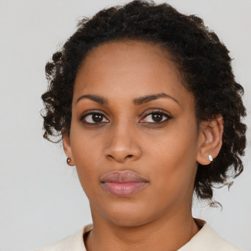 Neutral black young-adult female with medium  brown hair and brown eyes
