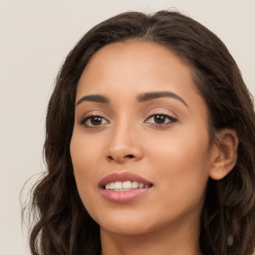 Joyful latino young-adult female with long  brown hair and brown eyes