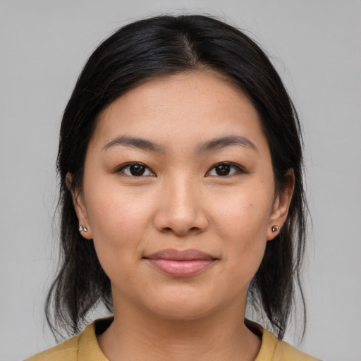 Joyful latino young-adult female with medium  brown hair and brown eyes