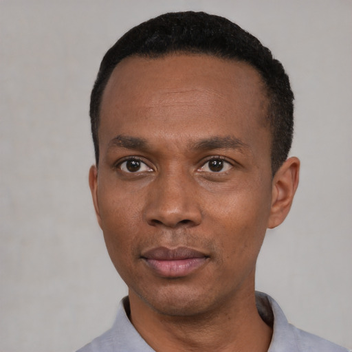 Neutral black adult male with short  black hair and brown eyes