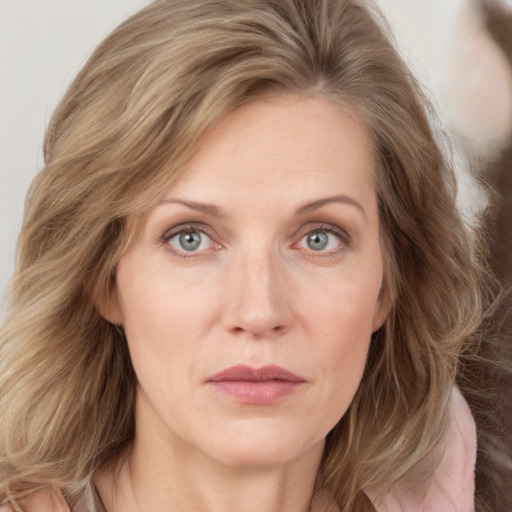 Joyful white young-adult female with long  brown hair and blue eyes