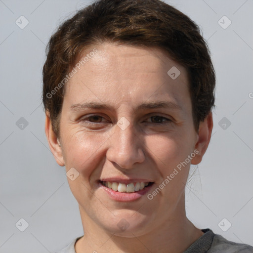 Joyful white adult female with short  brown hair and grey eyes