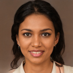 Joyful black young-adult female with medium  brown hair and brown eyes