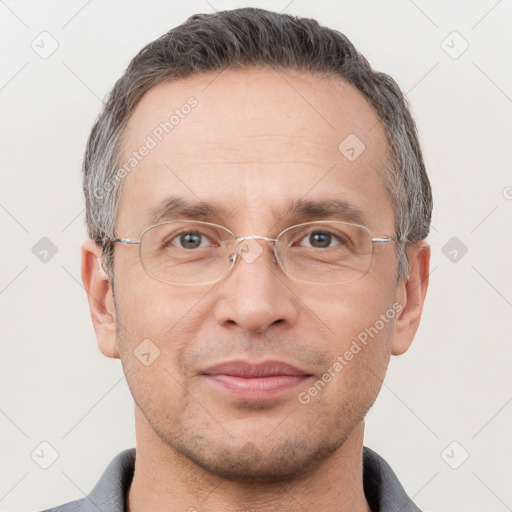 Joyful white adult male with short  brown hair and brown eyes