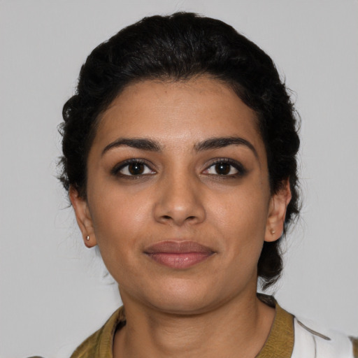 Joyful latino young-adult female with medium  black hair and brown eyes