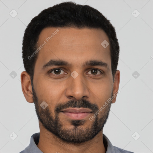 Joyful black young-adult male with short  black hair and brown eyes