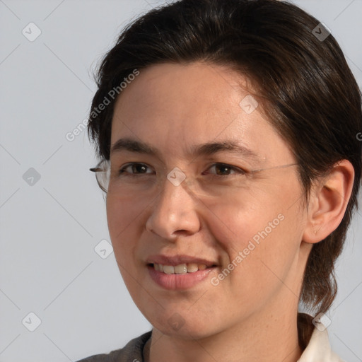 Joyful white adult female with medium  brown hair and brown eyes