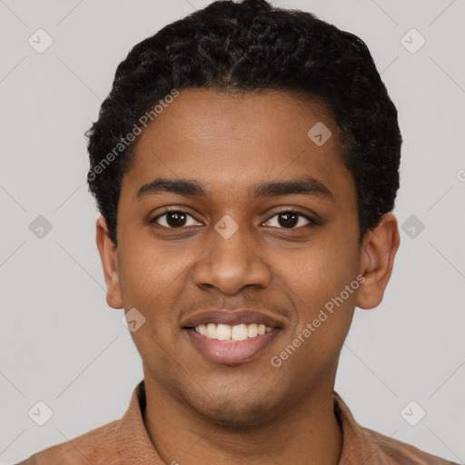 Joyful black young-adult male with short  black hair and brown eyes