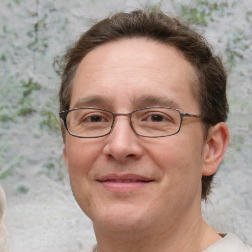 Joyful white adult male with short  brown hair and grey eyes