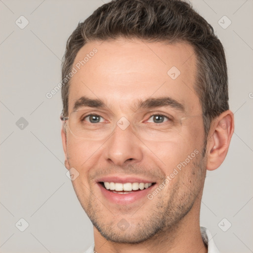 Joyful white adult male with short  brown hair and brown eyes