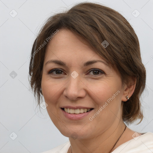 Joyful white adult female with medium  brown hair and brown eyes