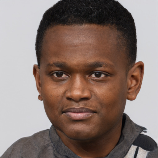 Joyful black young-adult male with short  brown hair and brown eyes