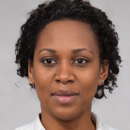 Joyful black young-adult female with medium  brown hair and brown eyes