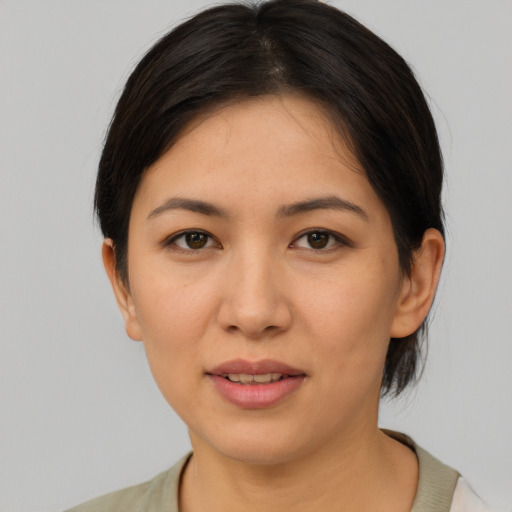 Joyful asian young-adult female with medium  brown hair and brown eyes