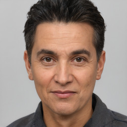 Joyful white adult male with short  black hair and brown eyes