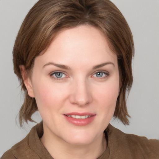 Joyful white young-adult female with medium  brown hair and blue eyes