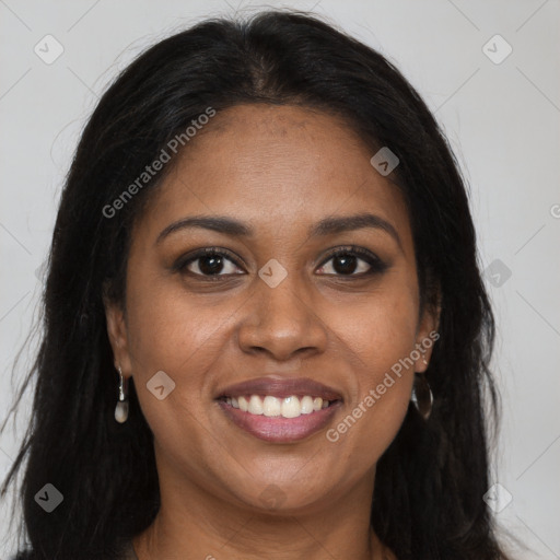 Joyful black young-adult female with long  brown hair and brown eyes