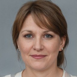 Joyful white adult female with medium  brown hair and grey eyes