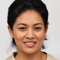 Joyful asian young-adult female with medium  brown hair and brown eyes