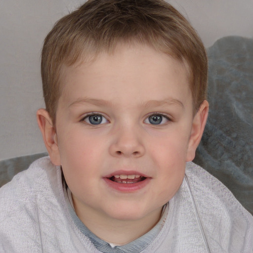 Joyful white child male with short  brown hair and blue eyes