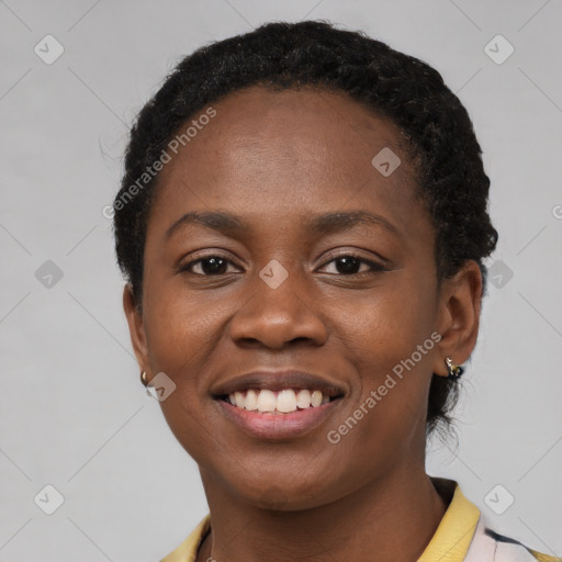 Joyful black young-adult female with short  black hair and brown eyes