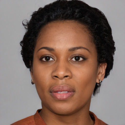 Joyful black young-adult female with medium  black hair and brown eyes