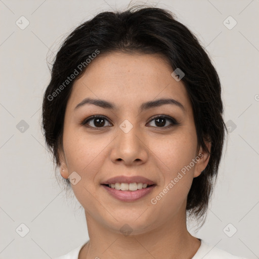 Joyful latino young-adult female with medium  brown hair and brown eyes