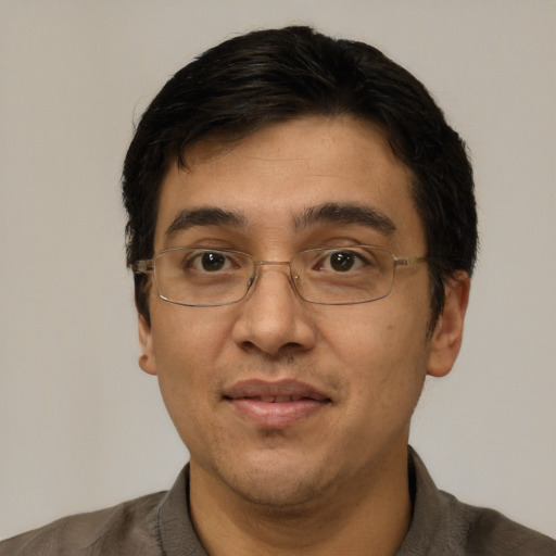 Joyful white adult male with short  black hair and brown eyes