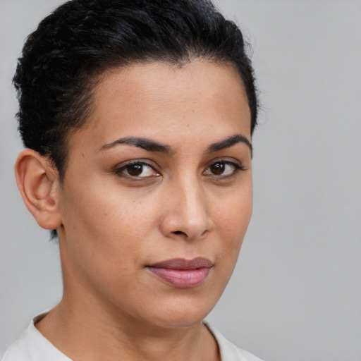 Joyful latino young-adult female with short  brown hair and brown eyes