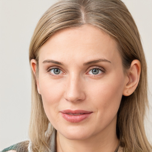 Joyful white young-adult female with long  brown hair and blue eyes