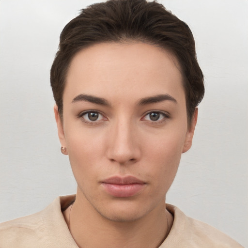 Neutral white young-adult female with short  brown hair and brown eyes