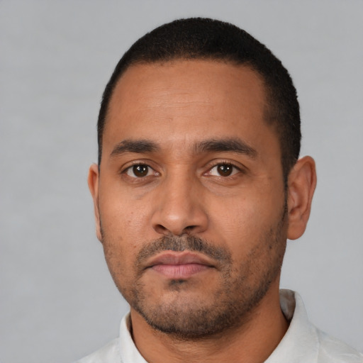 Neutral latino young-adult male with short  black hair and brown eyes