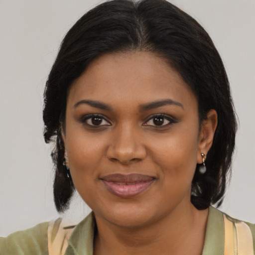 Joyful black young-adult female with medium  brown hair and brown eyes