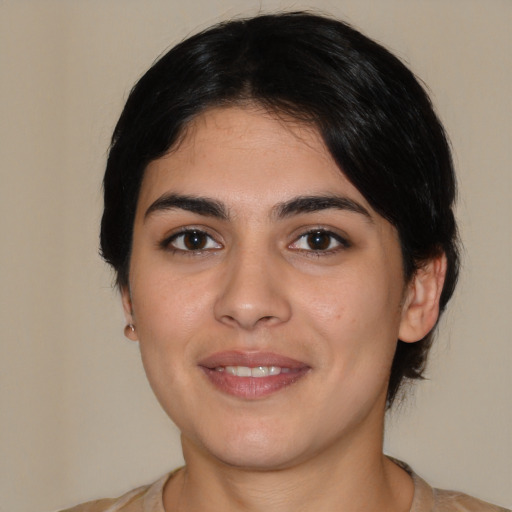 Joyful white young-adult female with medium  black hair and brown eyes