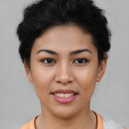 Joyful latino young-adult female with short  brown hair and brown eyes